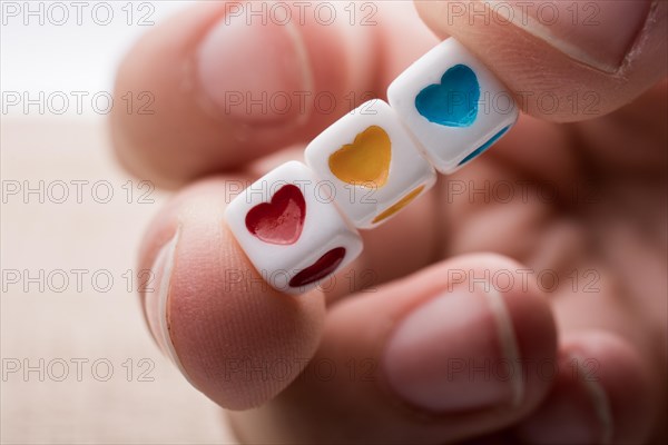 Colorful cubes with a heart in hand on canvas