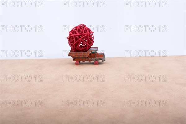Toy car truck isolated on white and wooden background