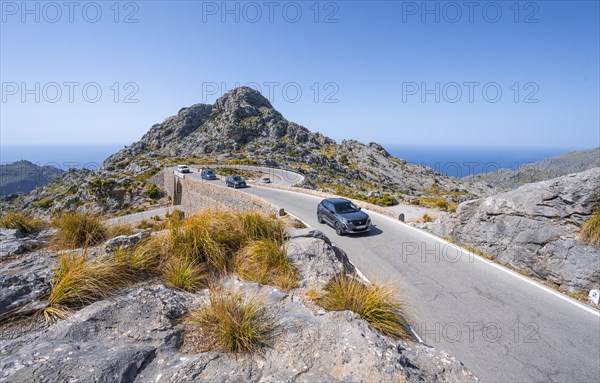 Car at the mountain pass with switchbacks to Sa Colobra