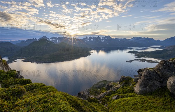 Sun star at sunset over the mountain peaks