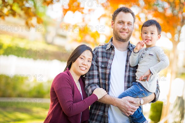 Outdoor portrait of multiethnic chinese and caucasian family