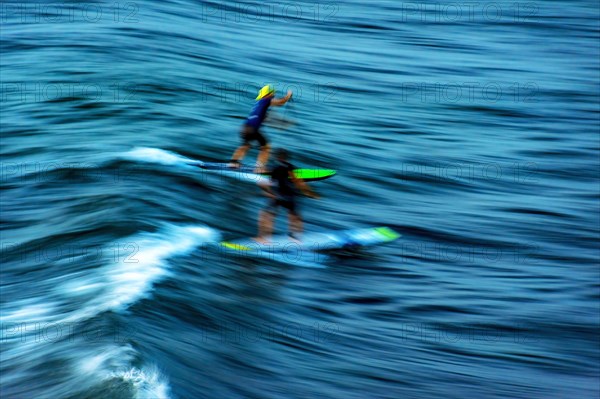 Stand up paddle on the waves at sunset