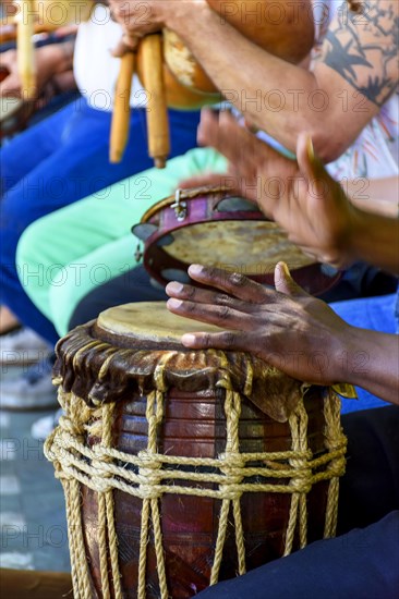 Percussionist playing a rustic and rudimentary percursion instrument