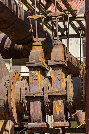 Corroded and rusty gears and pipes of old machinery for processing iron ore abandoned in Minas Gerais