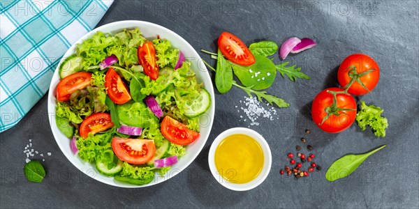 Mixed salad with fresh tomatoes healthy eating food from above banner on slate in Stuttgart