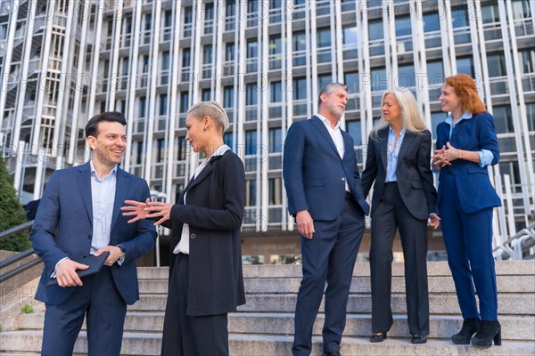 Senior Executives Share Ideas While Going Down Stairs in Commercial Building