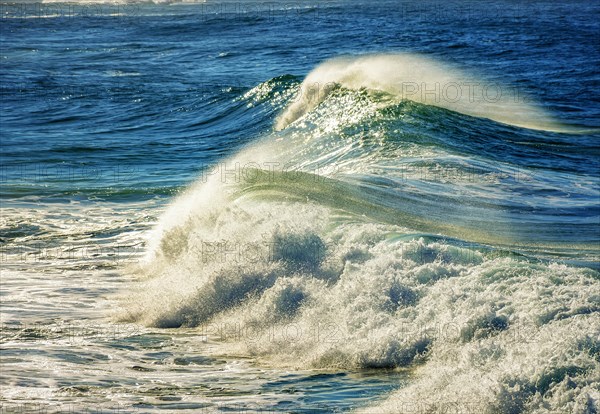 Waves breaking on the beach in the morning sun in Ipanema