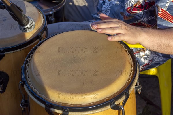 Detail of man playing atabaque during party at the carnival of the city of Belo Horizonte