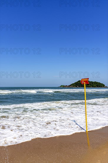 Paradise beach with danger warning from waves and sea currents in Bertioga in the state of Sao Paulo