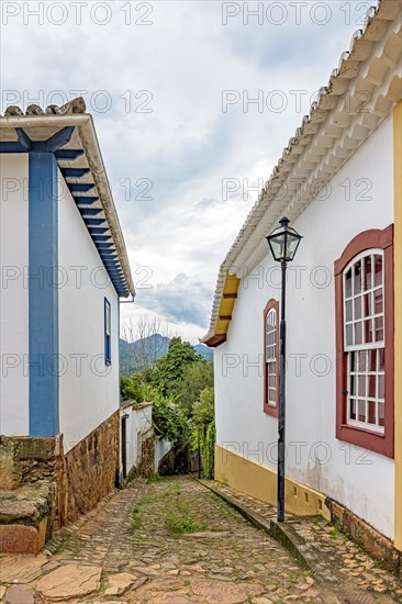 Old colonial-style alley with cobblestone street in the historic city of Tiradentes in Minas Gerais