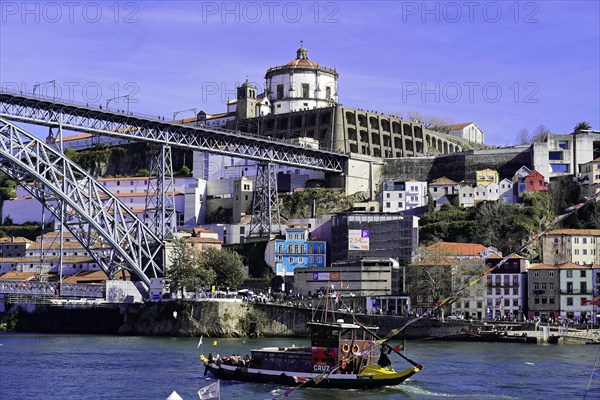 View of the Dom Luis I bridge over Douro River and terracota rooftops