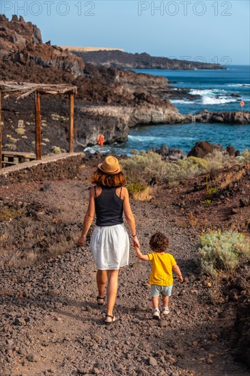 Mother and son on vacation by the beach of Tacoron on El Hierro
