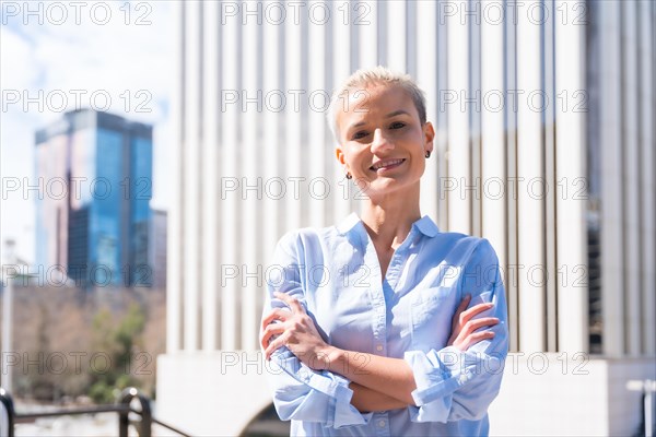 Portrait of executive professional white-haired woman in a business area