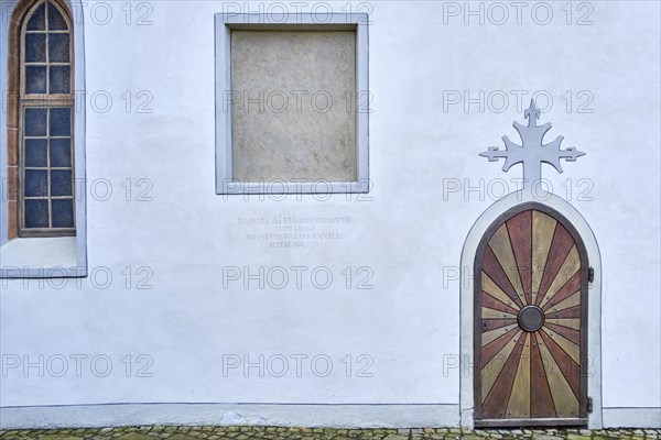 Arched door with cross on the top of the arch