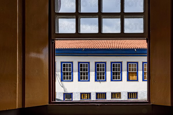 Old colonial style houses seen through a wooden window in the historic town of Diamantina in Minas Gerais