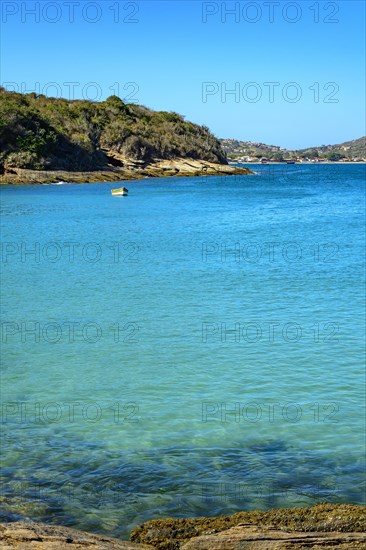 Small wooden fishing boat on the turquoise waters of Buzios on the north coast of Rio de Janeiro