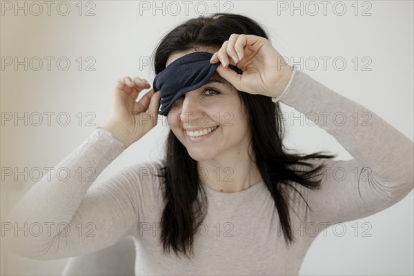 Happy woman with eye mask