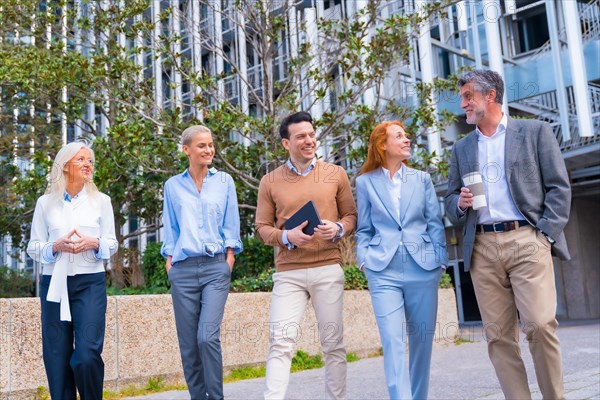 Group of coworkers walking going to work outdoors in a corporate office area