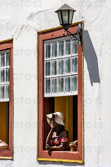 Window decorated with flowers and objects in the historic historic city of Diamantina in a typical scene of the interior of the state of Minas Gerais