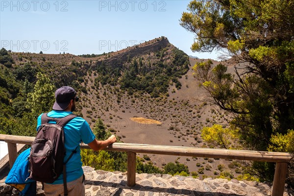 A young man at the Fireba volcano viewpoint of La Llania park in El Hierro