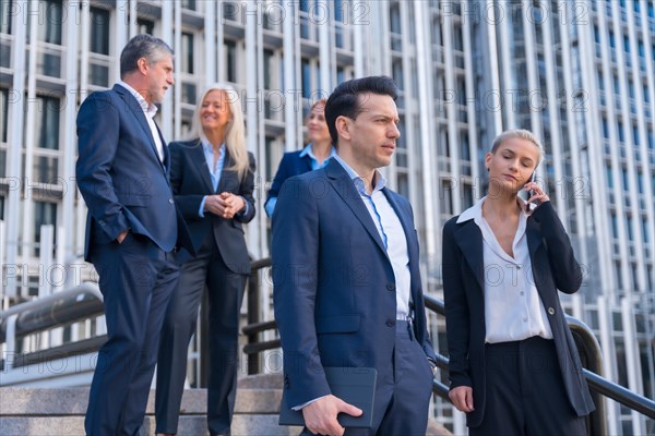 Senior Executives Talk Business While Descending Stairs in Office Building