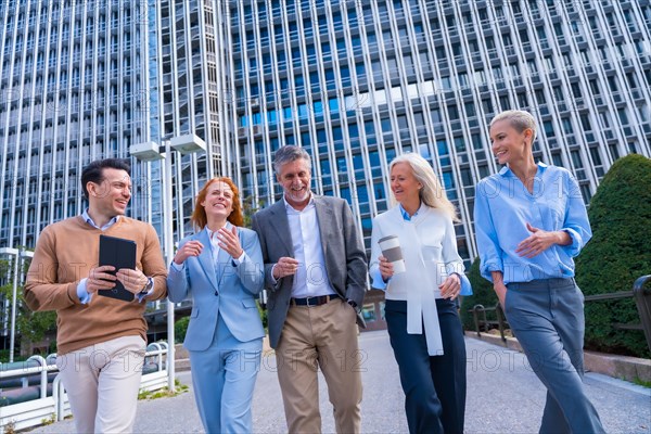 Group of coworkers walking going to work outdoors in a corporate office area