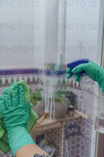 Hands of a woman with green gloves