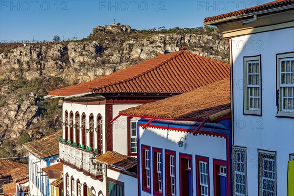 Detail of colonial style streets and houses in the old and historic city of Diamantina in Minas Gerais with the mountains in the background during the late afternoon