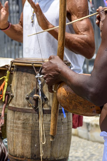 Musicians playing traditional instruments used in capoeira