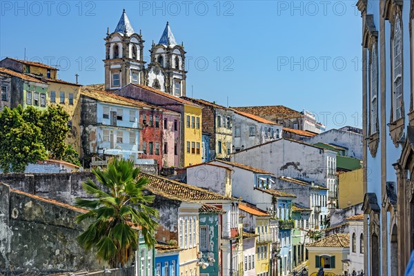 Colorful houses facades and historic church towers in baroque and colonial style with blue sky in the famous Pelourinho neighborhood of Salvador