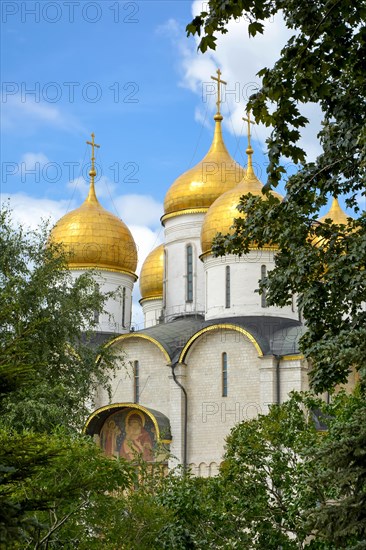 Orthodox Christian church with golden domes inside the Kremlin gardens in Moscow