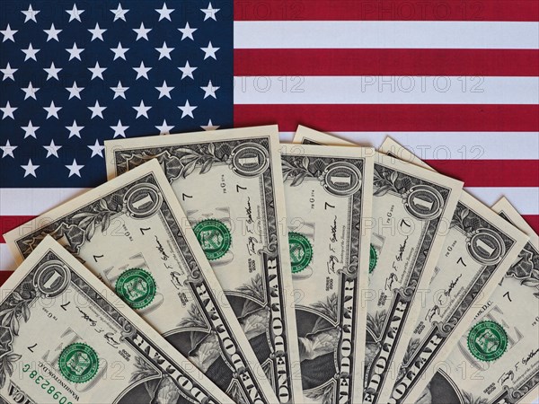 Dollar notes and flag of the United States