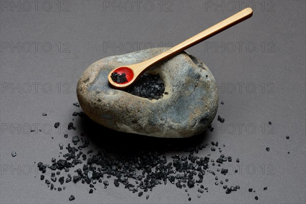 Black Hawaiian salt on spoons and in hollowed stone