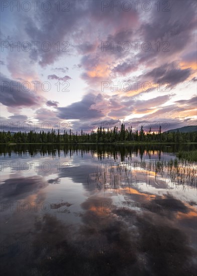 Dramatic sunset by the river Namsen with reflection