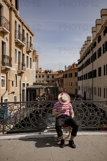 Gondoliers on a bridge in Venice