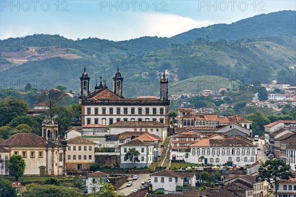 View of the historic city of Ouro Preto in Minas Gerais with its colonial-style houses and churches and the mountains in the background