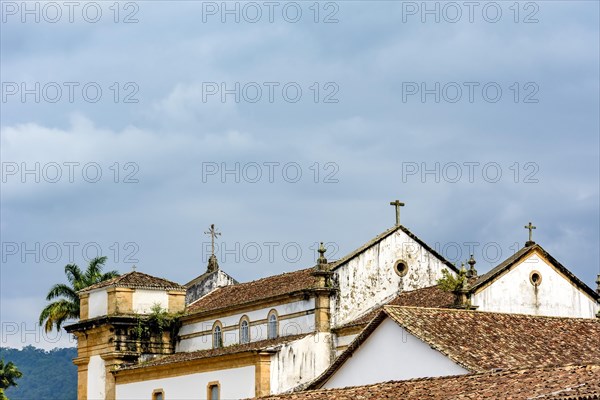 Back view of old colonial style church and roofs in the historic center of Paraty in overcast day