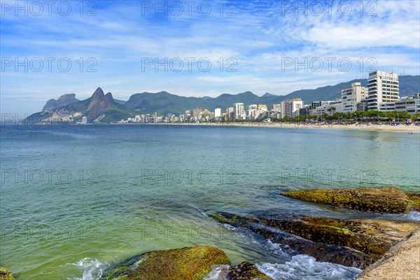 Ipanema beach in Rio de Janeiro still empty with its buildings and mountains around