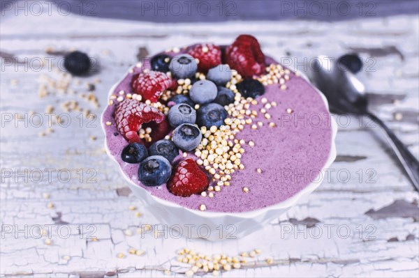 Healthy yogurt and fruit smoothie bowl decorated with raspberry