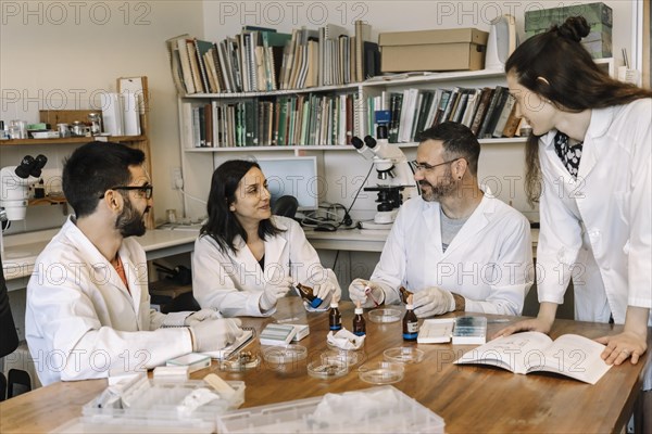 Biologists and scientists studying and researching in chemistry lab