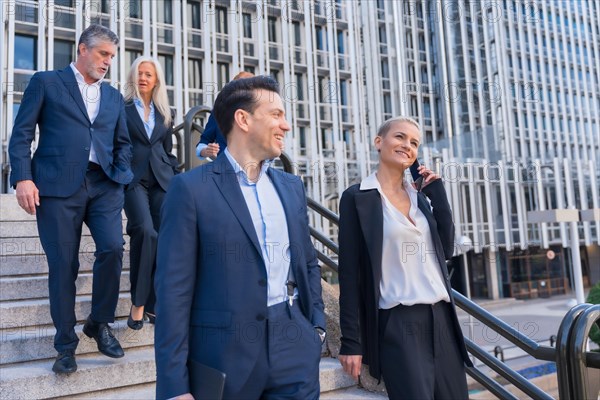 Senior Executives Collaborate While Going Down Stairs in Commercial Building