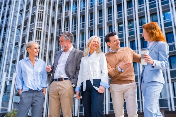 Cheerful group of coworkers outdoors in a corporate office area