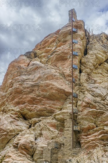 Metal water level gauge in a reservoir emptied by drought and climate change