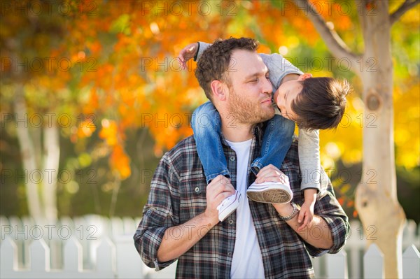 Outdoor portrait of multiethnic chinese and caucasian father and son