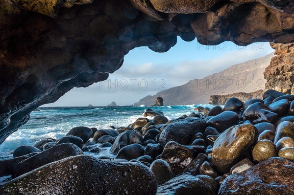 Natural arch of stones next to the La Maceta rock pool on the island of El Hierro en la Frontera