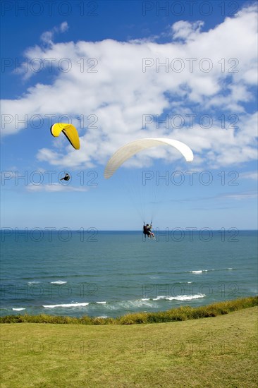 Paragliders flying over the sea in the city of Torres in the state of Rio Grande do Sul