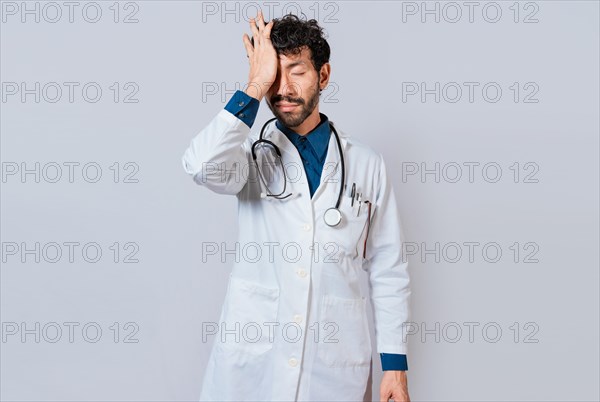 Tired doctor with hand on forehead