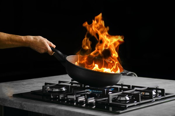 Process of flambering food ingredients in a frying pan