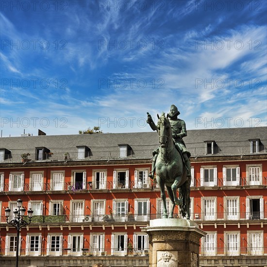 Equestrian statue of Philip III in front of residential buildings on the Plaza Mayor