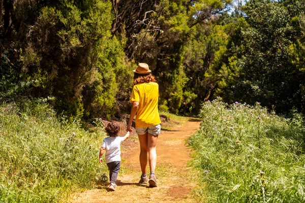 A mother with her son enjoying on the La Llania trekking trail in El Hierro